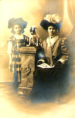 Woman and Girl with Fancy Hats and a Dog on a Column