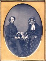 Chase - Portrait of a Seated Couple Posed with Their Dog Between Them