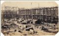 B. L. Spackman (attributed to) - Construction of the 1862 International Exhibition at South Kensington [Early Construction View with Man & Child Sitting on Lumber]