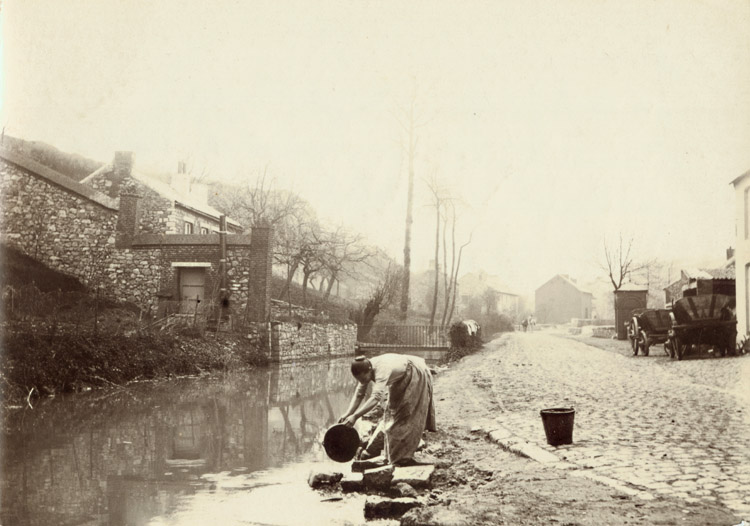 Woman Drawing Water from a Stream