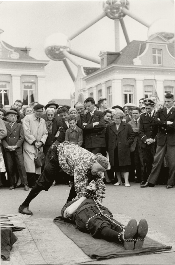 Henri Cartier-Bresson - Escape-Artist Performance in front of Atomium, Brussels World Fair