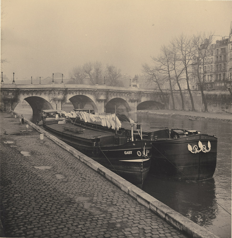 Barges with Laundry along the Seine with Pont Neuf in Background, Paris
