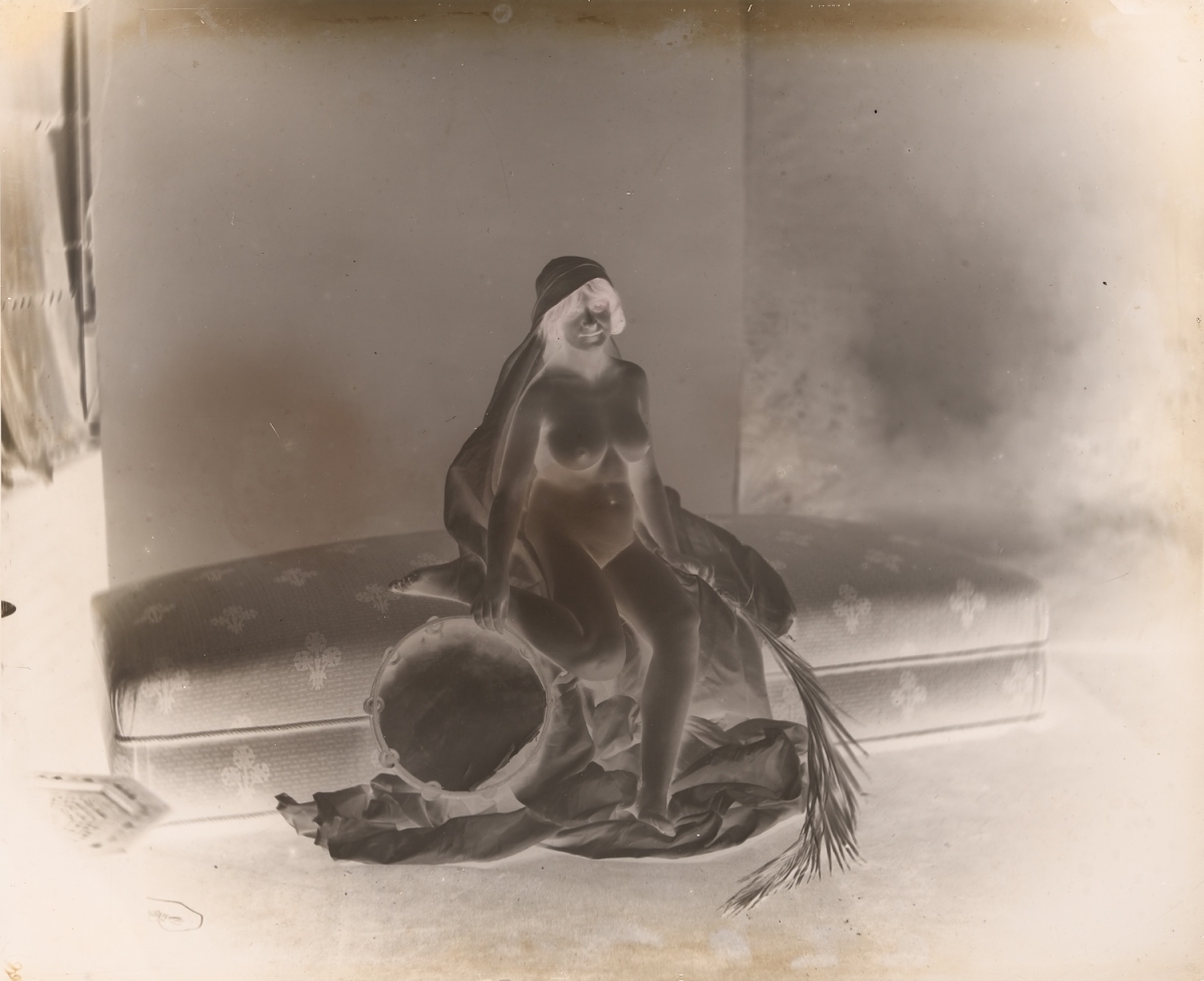 Female Nude Seated on Couch with Tambourine