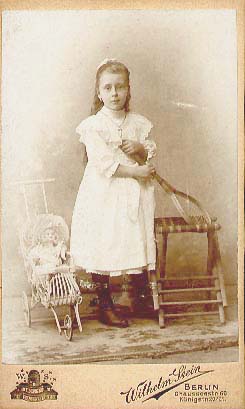 Little Girl with Tennis Racket and Her Doll in a Carriage