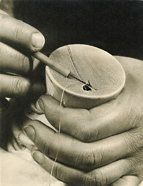 Man's Hands Repairing Stitching
