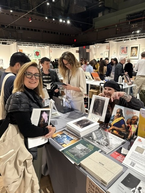 Santa Bannon was pointing out some of the books for sale to a customer at the Photo Review table at AIPAD. The Photo Review is celebrating its 50th Anniversary this year.