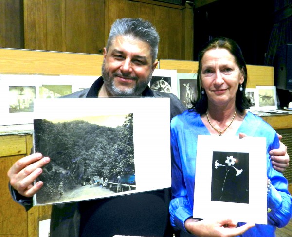 French Dealer Olivier DeGeorges and Jane Orde showing off a few of their photos at their table.