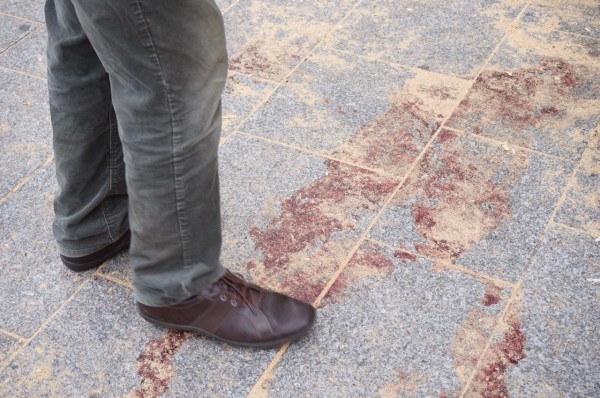 Standing in the blood of a shooting victim.  (Photo courtesy and copyright 2015 Steven Evans)