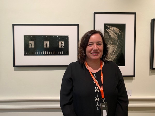 Sarah Greene of Blue Lotus with works by Fan Ho. (Photo by Michael Diemar)